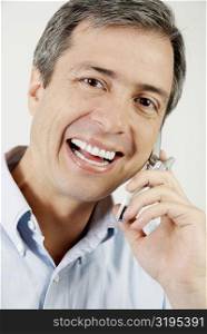 Portrait of a mature man talking on a mobile phone and smiling