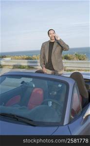 Portrait of a mature man talking on a mobile phone in a car