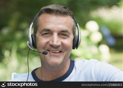 Portrait of a mature man wearing a headset and smiling