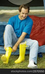 Portrait of a mature man wearing galoshes