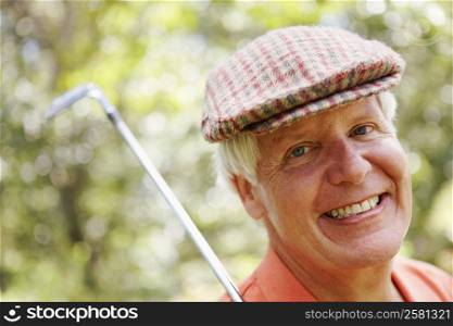 Portrait of a mature man with a golf club