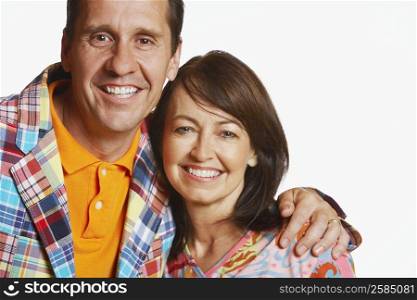 Portrait of a mature man with his arm around a mature woman and smiling