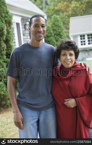 Portrait of a mature man with his arm around a mature woman and smiling