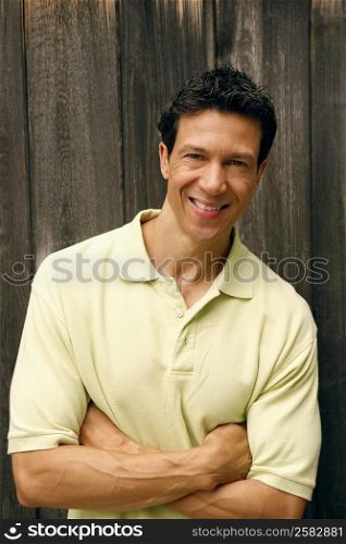 Portrait of a mature man with his arms crossed smiling