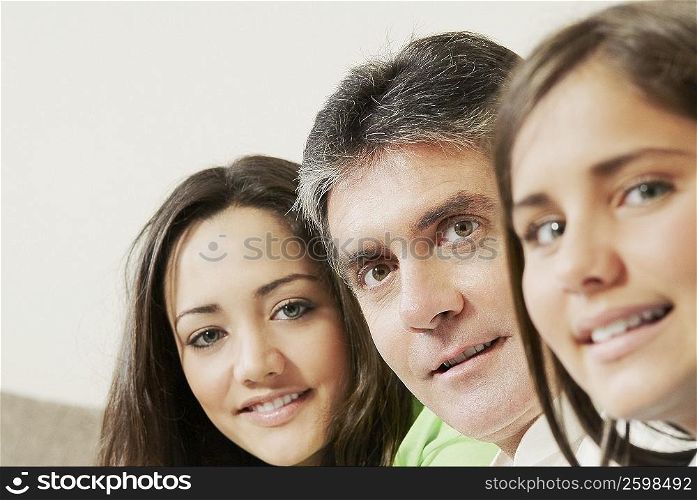 Portrait of a mature man with his two daughters