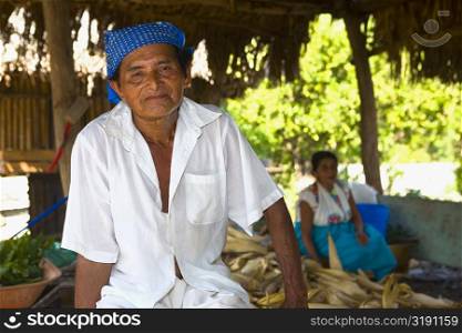 Portrait of a mature man with his wife in the background, Papantla, Veracruz, Mexico