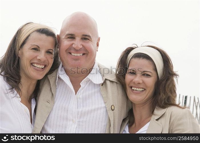 Portrait of a mature man with two mature women smiling together