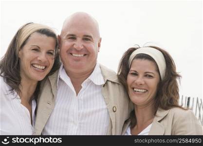 Portrait of a mature man with two mature women smiling together