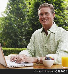 Portrait of a mature man working on a laptop