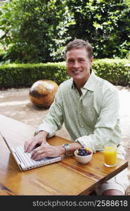 Portrait of a mature man working on a laptop