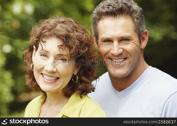 Portrait of a mature woman and a mid adult man smiling