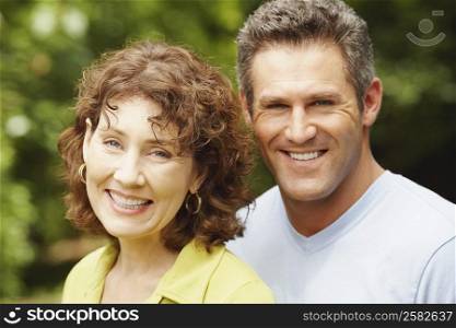 Portrait of a mature woman and a mid adult man smiling