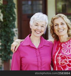 Portrait of a mature woman and a senior woman standing together and smiling