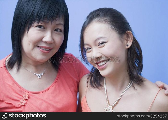 Portrait of a mature woman and her daughter smiling