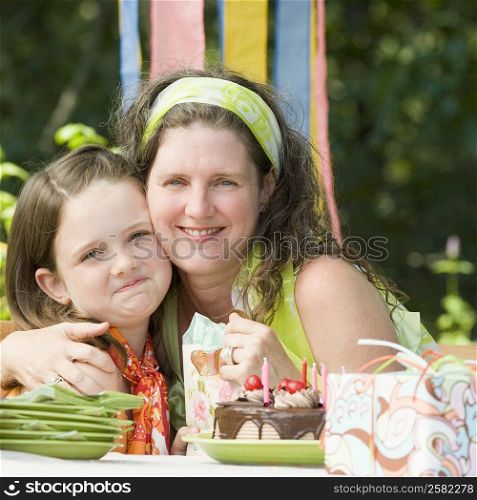 Portrait of a mature woman celebrating her birthday with her daughter