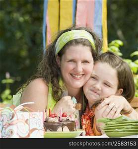Portrait of a mature woman celebrating her birthday with her daughter