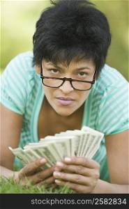 Portrait of a mature woman counting paper currency