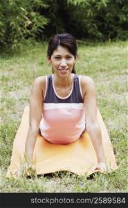 Portrait of a mature woman doing yoga on the lawn