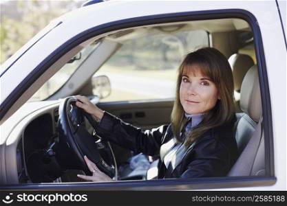 Portrait of a mature woman driving a car