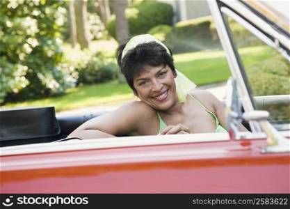 Portrait of a mature woman driving a car and smiling