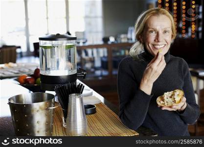 Portrait of a mature woman eating a cutlet