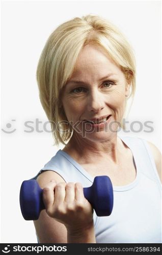 Portrait of a mature woman exercising with a dumbbell