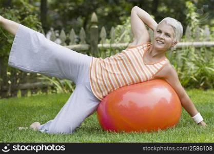 Portrait of a mature woman exercising with a fitness ball