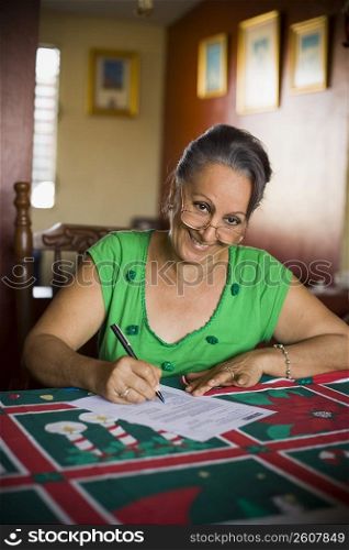 Portrait of a mature woman filling up a form
