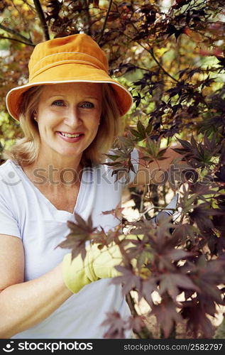 Portrait of a mature woman gardening and smiling