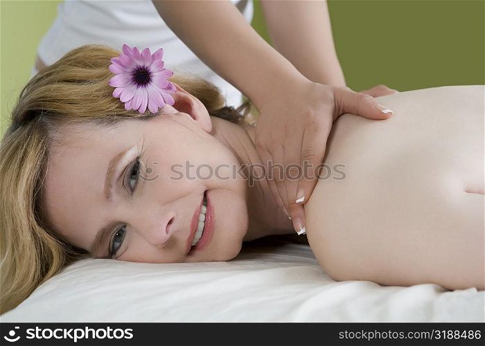 Portrait of a mature woman getting a shoulder massage from a massage therapist