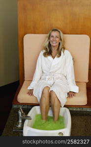 Portrait of a mature woman getting pedicure