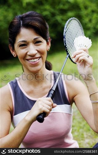 Portrait of a mature woman holding a badminton racket and a shuttlecock