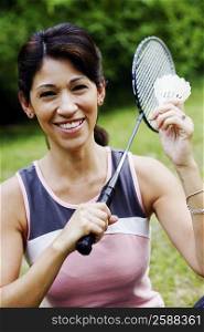 Portrait of a mature woman holding a badminton racket and a shuttlecock