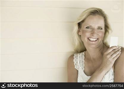 Portrait of a mature woman holding a credit card and smiling
