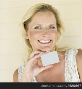 Portrait of a mature woman holding a credit card and smiling