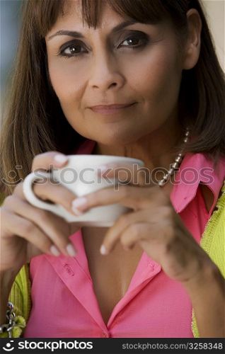 Portrait of a mature woman holding a cup of coffee