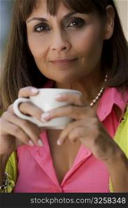 Portrait of a mature woman holding a cup of coffee