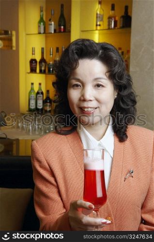 Portrait of a mature woman holding a glass