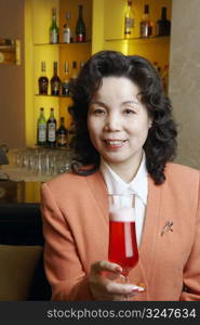 Portrait of a mature woman holding a glass