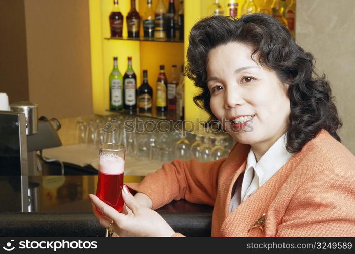 Portrait of a mature woman holding a glass