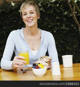 Portrait of a mature woman holding a glass of juice