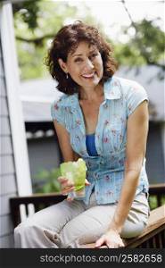 Portrait of a mature woman holding a glass of lemonade