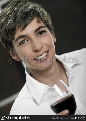 Portrait of a mature woman holding a glass of red wine