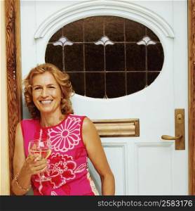 Portrait of a mature woman holding a glass of white wine