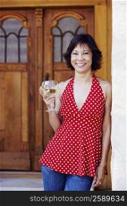 Portrait of a mature woman holding a glass of white wine