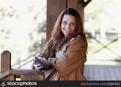 Portrait of a mature woman holding a mobile phone and smiling
