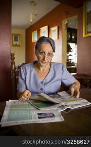 Portrait of a mature woman holding a newspaper