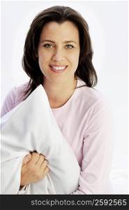 Portrait of a mature woman holding a pillow