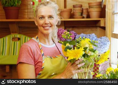 Portrait of a mature woman holding a vase