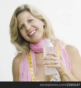 Portrait of a mature woman holding a water bottle and smiling